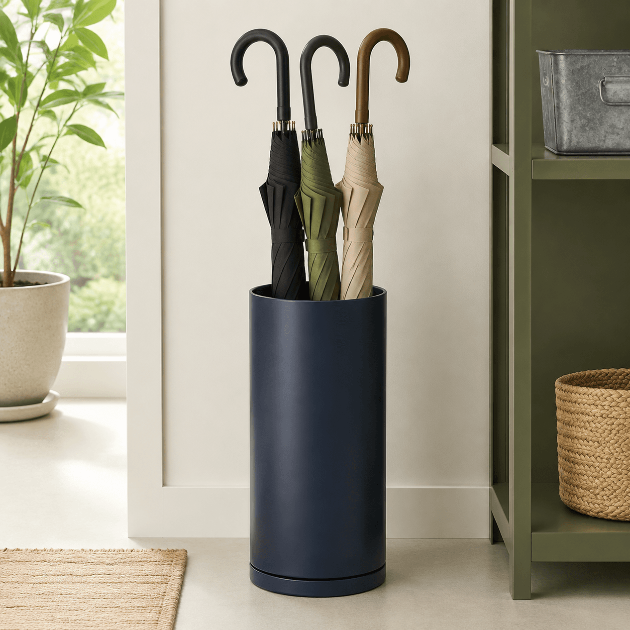 Umbrella Stand — A weighted metal stand with a removable drip tray.